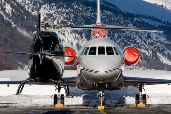 Megeve-Helicopters_Helicopter-hovering-next-to-Private-Jet-at-Chambery-Airport